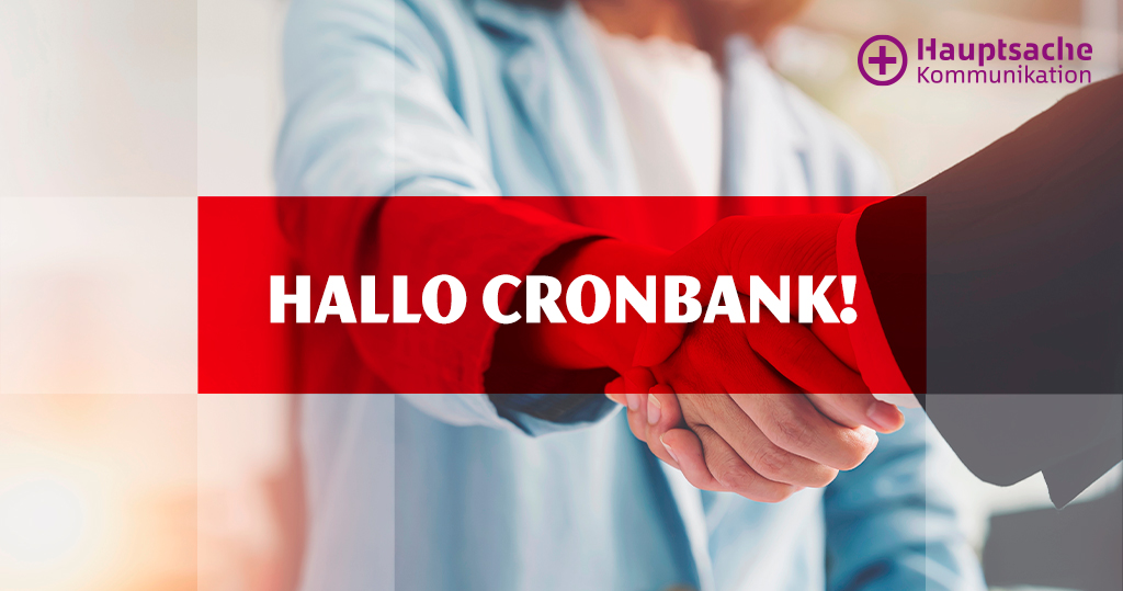 Zu sehen ist ein Foto, auf dem sich zwei Menschen die Hände schütteln, darüber ein roter Balken mit den Worten "Hallo Cronbank!"; oben rechts das Hauptsache-Kommunikation-Logo.